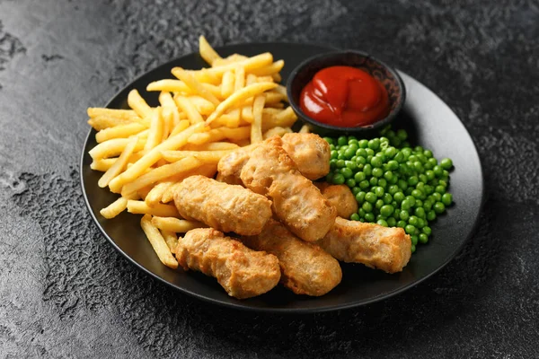 Irish battered sausages with potato fries, green peas and ketchup.