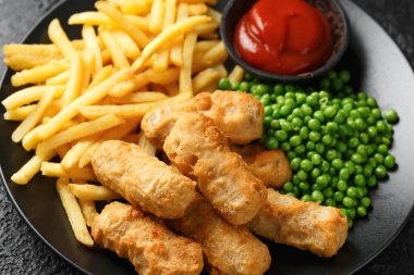 Irish battered sausages with potato fries, green peas and ketchup.