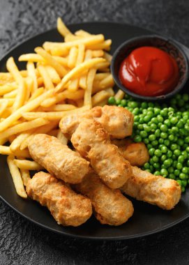 Irish battered sausages with potato fries, green peas and ketchup.