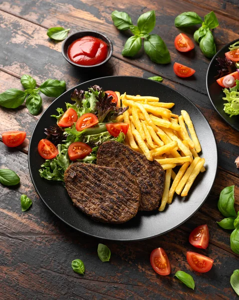 stock image Peppered Vegetarian steaks served with french fries and salad.