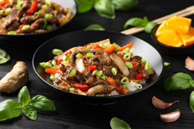 Stir fry Crispy Orange Beef with sweet peppers, onion and rice. Asian food. clipart