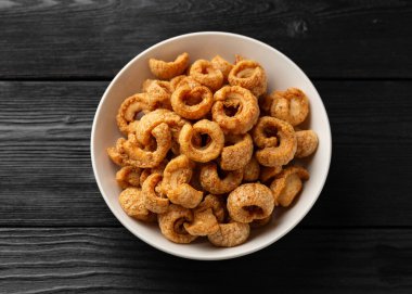 Çıtır çıtır domuz eti çıtırdıyor, kaşınıyor. Kızartmalar beyaz kasede.