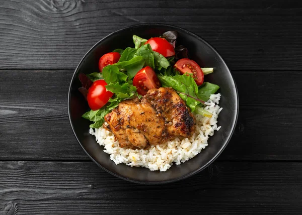 Baked balsamic chicken thighs with rice and vegetables.