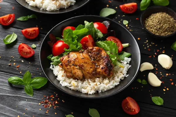 Baked balsamic chicken thighs with rice and vegetables.