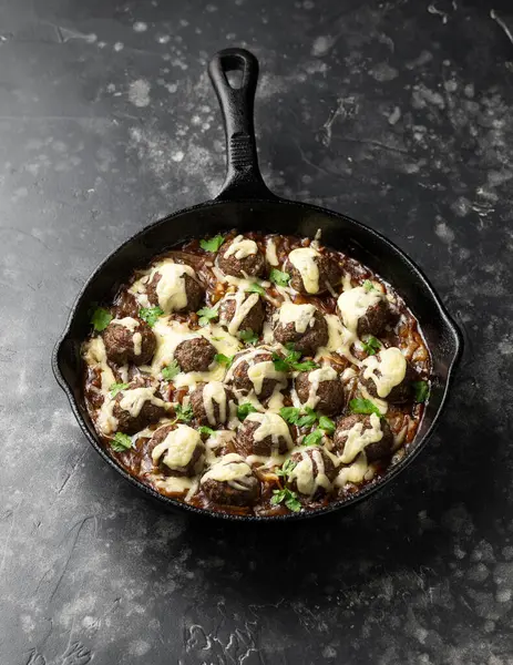French onion beef meatballs in iron cast pan