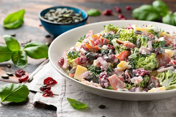 stock image Healthy Homemade Broccoli Salad with bacon, red onion, cranberries, pumpkin seeds and cheese.