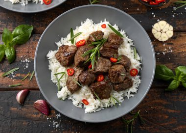 Garlic butter beef steak bites with rice. clipart