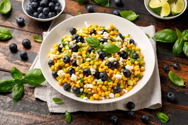 stock image Blueberry Corn Feta Salad in white plate on wooden table. Healthy food.