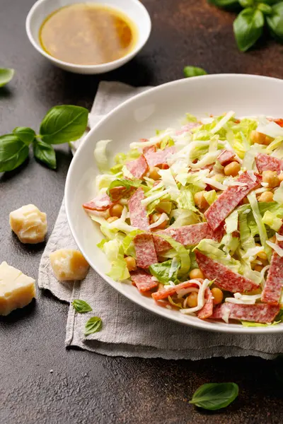 stock image La Scala Salad with romaine lettuce, salami, mozzarella cheese and chickpeas in white plate