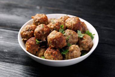Homemade beef and pork meatballs on baking paper.