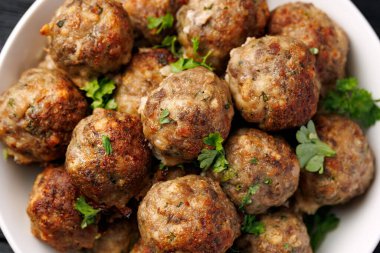 Homemade beef and pork meatballs on baking paper.