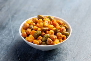 Sweet chilli Crunch protein packed mix of baked corn pieces, edamame beans, chickpeas and corn hoops. Healthy snack concept.