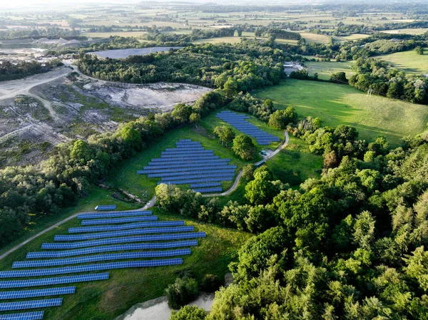 田園地帯に設置された太陽光発電所における太陽光発電パネルの空中図 ストックフォト