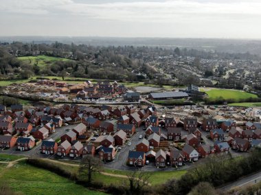 Housebuilding on a green field site on the edge of Wimborne Minster in Dorset in the UK seen from a drone clipart