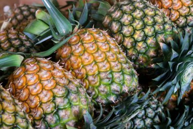 pile of pineapple fruit on market tray