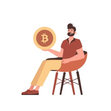 Adam sandalyede oturuyor ve elinde bir bitcoin tutuyor..