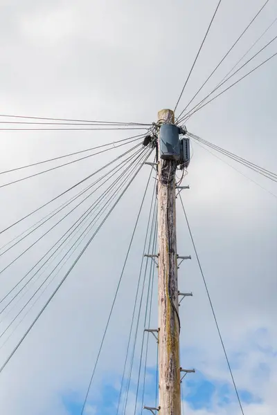 Utility pole with lots of cables connected, England, UK