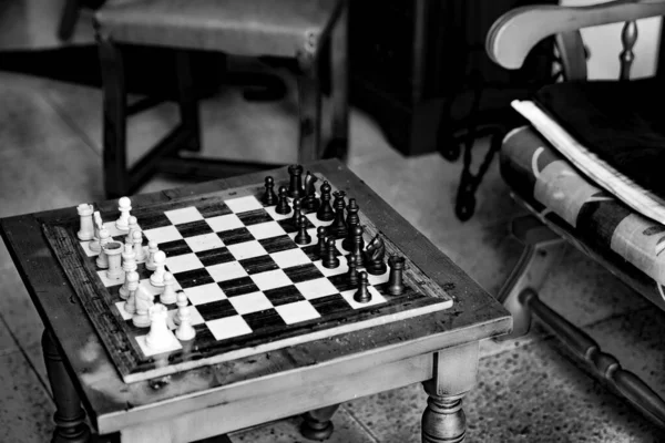 Old chess game on vintage table in black and white