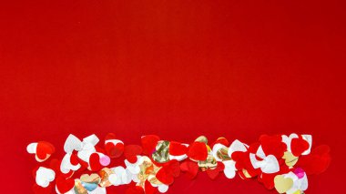 Hearts of paper on red textured background. San Valentine day concept. Copy space