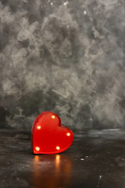 Red lighted heart on a black bacground. Copy space. Valentine concept.vat not