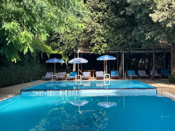 stock image Tirana, Albania. July 2023 :Blue Sun beds beside swimming pool. summer holidays in Albania.