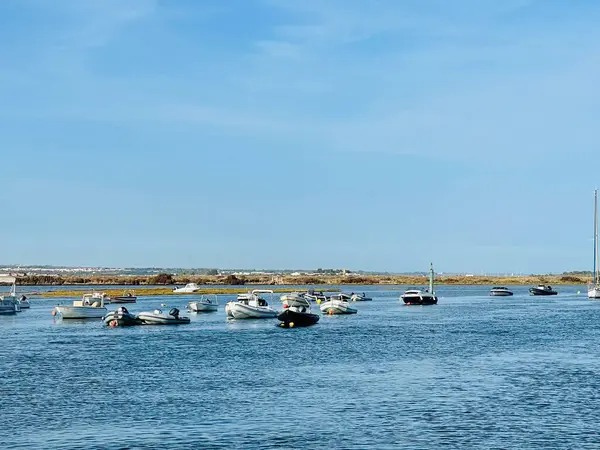 stock image Canal de Tavira , Eastern Algarve.Portugal. Small boat cruising tranquil green river. 