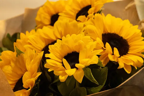 A beautiful bouquet of sunflowers stands in a vase . Bouquet for birthday , wedding ,in rustic style. copy space. Selective focus . Horizontal photo.