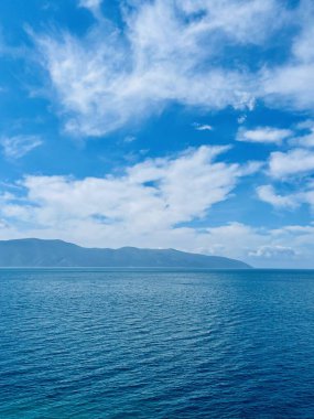 Vlore Arnavutluk 'taki İoninan Denizi üzerinde günbatımı manzarası. Sakin dalgalarla dalgalanan güzel bir su. Dikey fotoğraf. Uzayı kopyala Yaz tatili kavramı. 