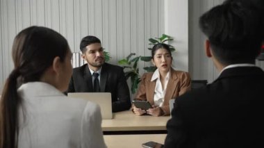Asian Business Team Discuss in Meeting About New Project