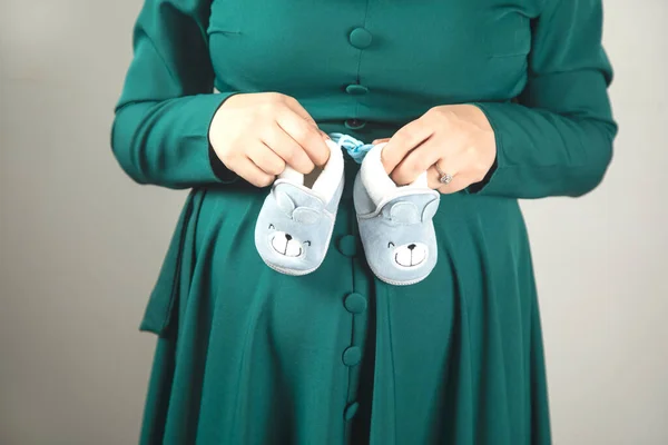 Young Pregnant Woman Hand Baby Shoes Royalty Free Stock Images