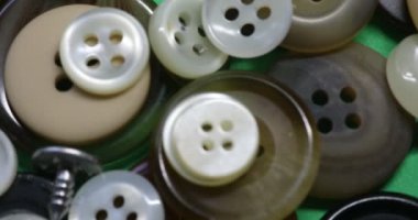 a large number of buttons for clothes in a heap