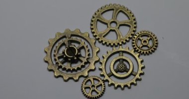 Brass gears are interlocked and form a gear or clockwork