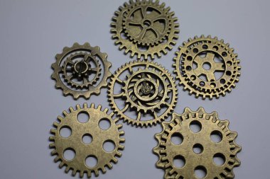 Brass gears are interlocked and form a gear or clockwork