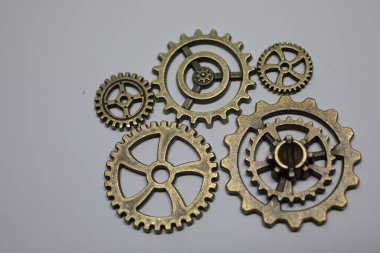 Brass gears are interlocked and form a gear or clockwork