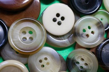 a large number of buttons for clothes in a heap
