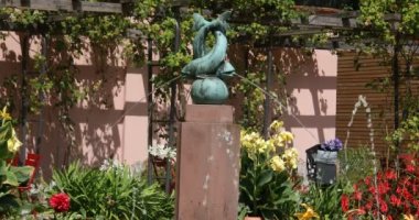 a dolphin fountain in the franfurt chinese garden