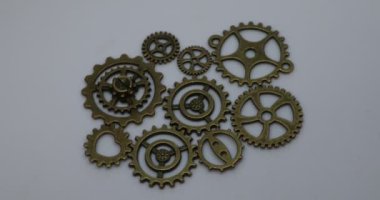 Brass gears are interlocked and form a gear or clockwork