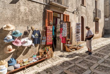Erice, Sicily, Italy - September 20, 2016: Tourists visiting typical shops in the historic center of Erice, province of Trapani.