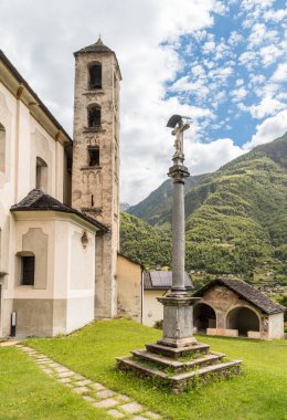 Bell tower of the Beata Vergine Assunta church with the crucified in churchyard, Semione (Serravalle), Ticino, Switzerland clipart