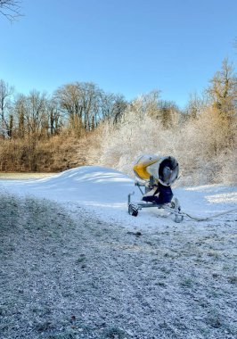 The snow cannon is used for producing artificial snow on ski slopes. Artificial snow system. clipart