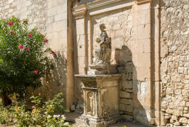 Ragusa Ibla, Sicily, Italy - October 7, 2024: Sculpture of Santa Anna e Maria SS.Bambina outside the ancient Church of St. James the Apostle in the Ibleo Gardens of Ragusa clipart