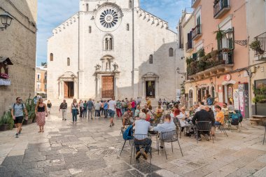 Bari, Puglia, Italy - October 10, 2023: People visit the square in front of the Metropolitan Cathedral-Basilica of San Sabino, located in the historic center of Bari. clipart