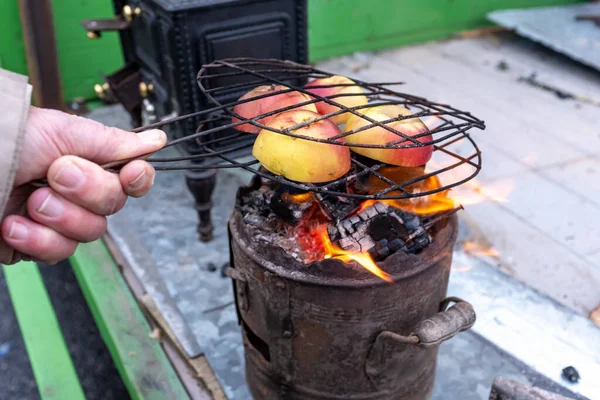 Apples in a grill above the flame