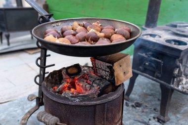 Kestaneler eski bir odun sobasının üstünde kızarıyor.