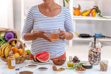 Woman , cut face a cup of tea in her hand, surrounded by cereals, fresh fruits and dried fruits, honey, clipart