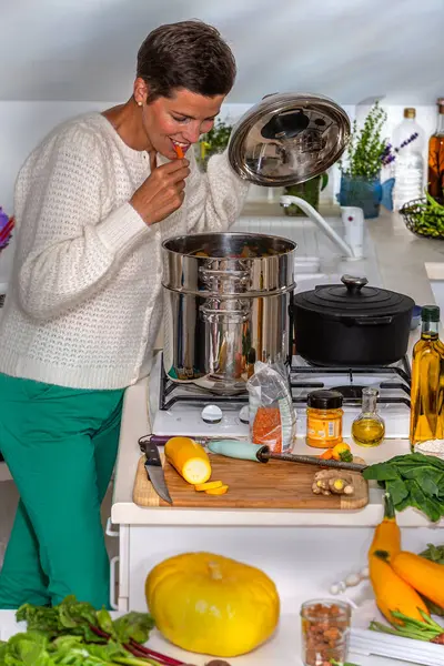 Woman Testing Carrot Crunchy Enough Royalty Free Stock Photos