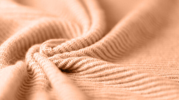Coral pink  alpaca wool texture as background with copy space. Trenda color 2024 year Peach Fuzz backdrop.