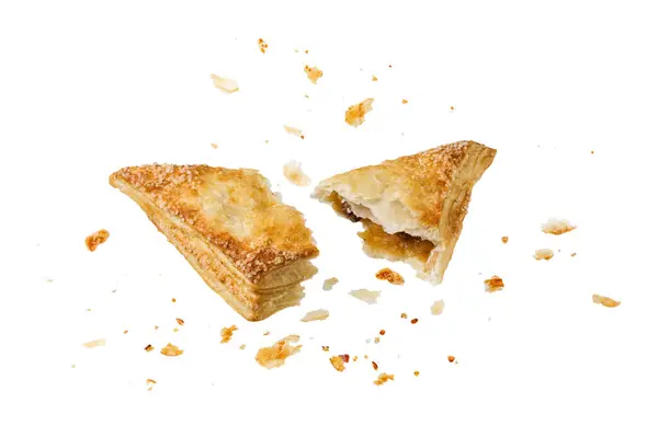 stock image Broken in half fresh baked pastry puff pie apple turnover with crumbs isolated on white background. Pastry card.