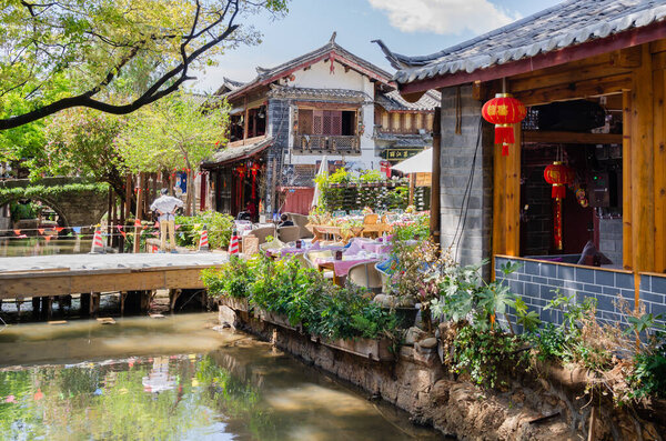 Lijiang, China - April 10,2017 : Scenic view of the restaurant in Old Town of Lijiang in Yunnan, China. People can seen exploring around it.