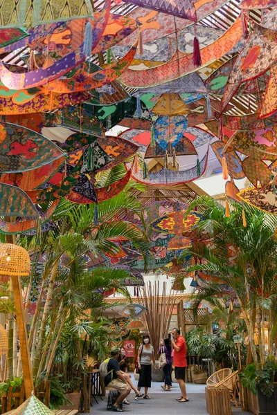 stock image Kuala Lumpur,Malaysia - April 21,2023 : Traditional Colourful Malay Wau kites and decorations at the wau-themed kampung during Hari Raya at Mid Valley Megamall. People can be seen exploring around it.